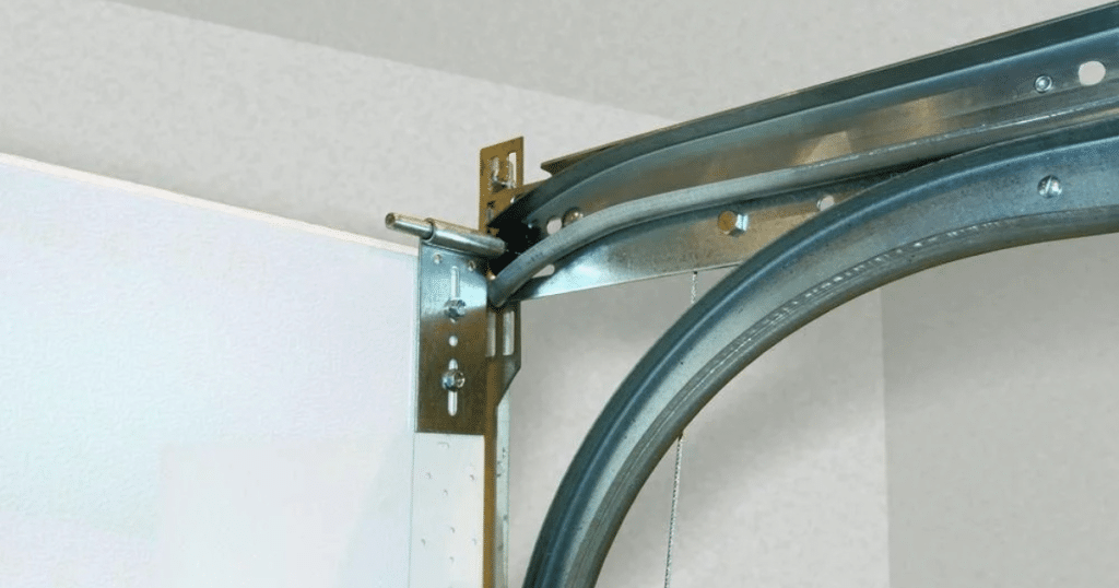 Metal garage door tracks mounted on the ceiling with brackets and rollers.