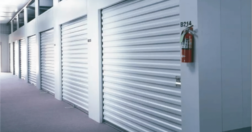 Several rows of metal storage units with roll-up doors.